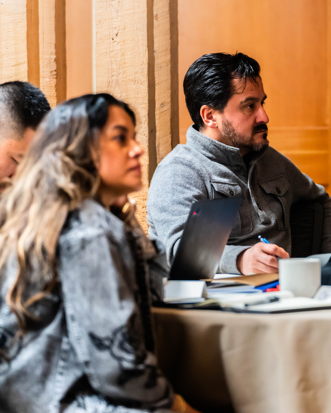 Workshop attendees taking notes and listening intently